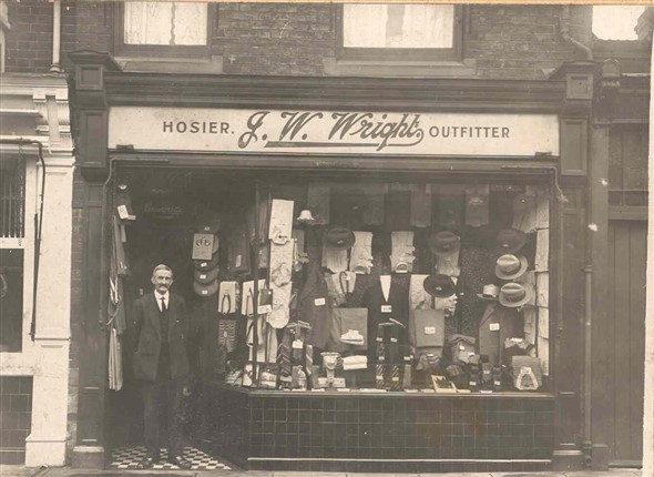 Photo:Mr John W. Wright standing outside his men's outfitters shop, 57 High Street, Gorleston, 1922-1925