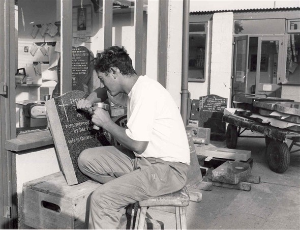 Photo:Glen Thain using traditional tools to hand carve a headstone, 1991