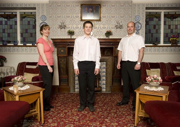 Photo:Portrait of Greg and Samantha Haddon with their son Tom in the entrance hall of their guesthouse