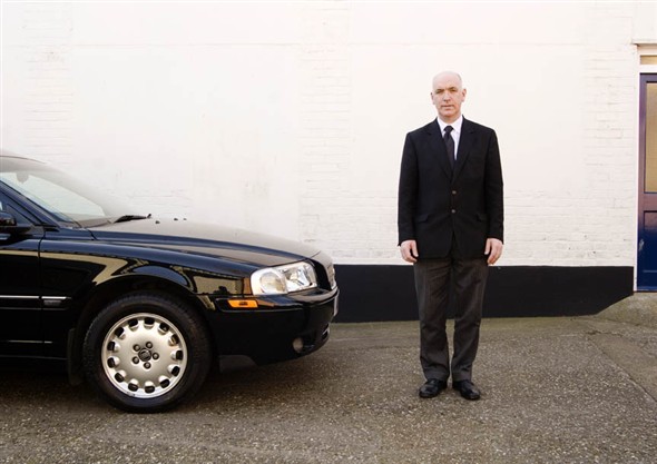 Photo:Portrait of Undertaker Michael Nelson with one of the hearses