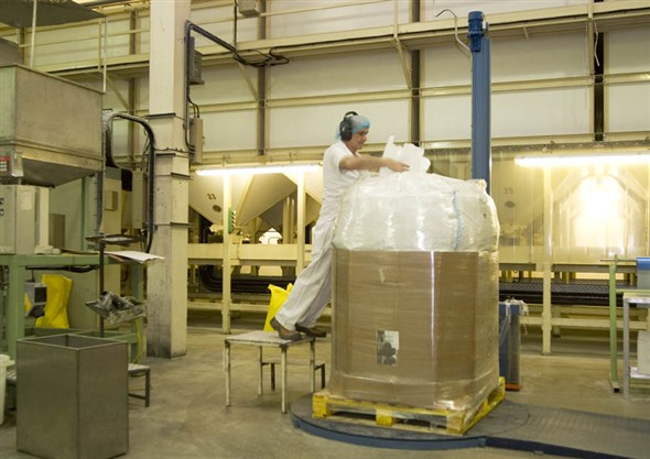 Photo:Portrait of Ray Amis packing pallets of pasta for transporting