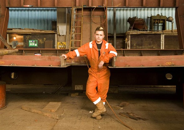 Photo:Portrait of Liam Sones, aprentice at Richards, standing by part of a ship he is welding