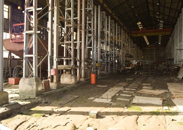 Photo:View of the inside of the boat building shed from the river