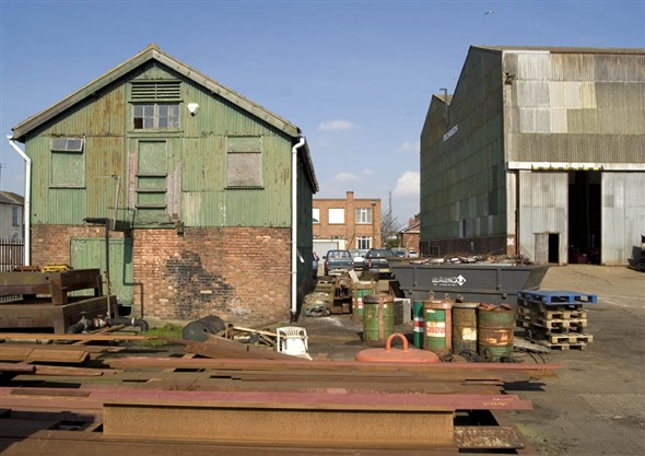 Photo:View of the ship yard with the boat building shed and the offices in the background