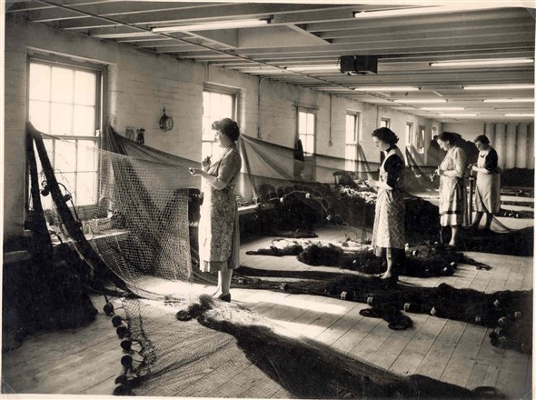 Photo:Beatsters at work, mending nets, 1950's